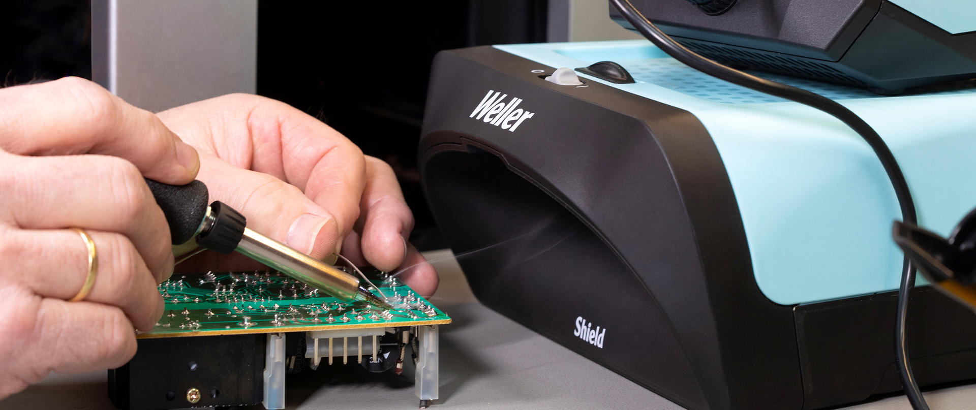 experienced solderer with fume extraction unit